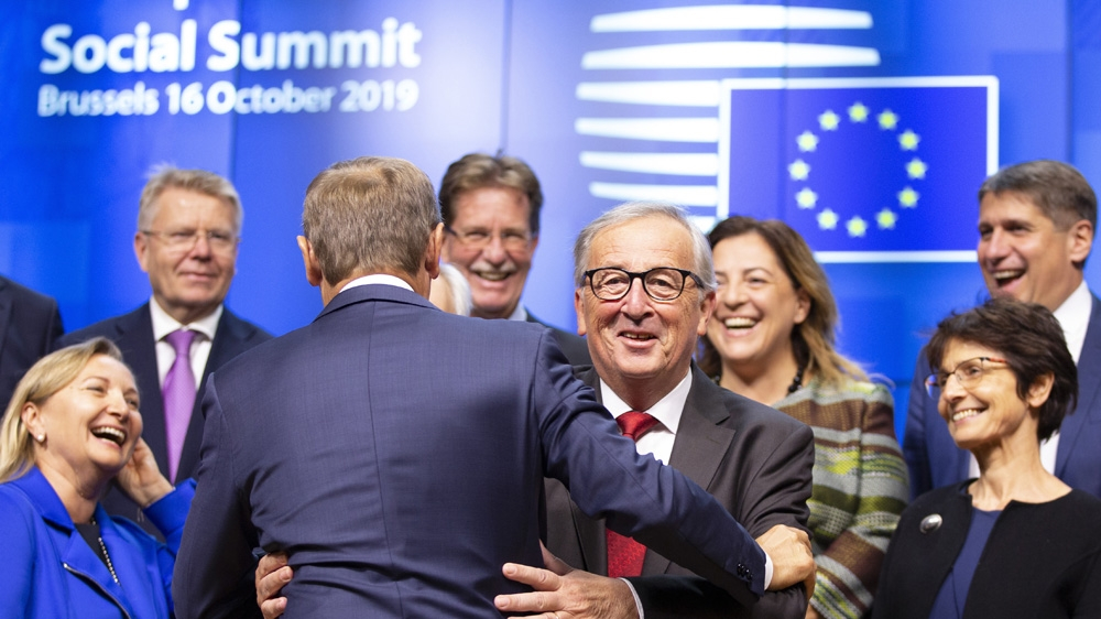 Members of the EU parliament expressing happiness after reaching an agreement