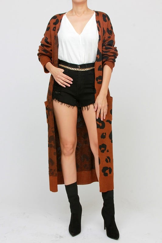 Model wearing Leopard Print Cardigan by Simi from various angles; cardigan is burnt sienna colored with large prints.