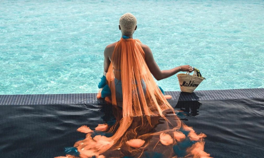 beautiful woman sitting in the water in Maldives