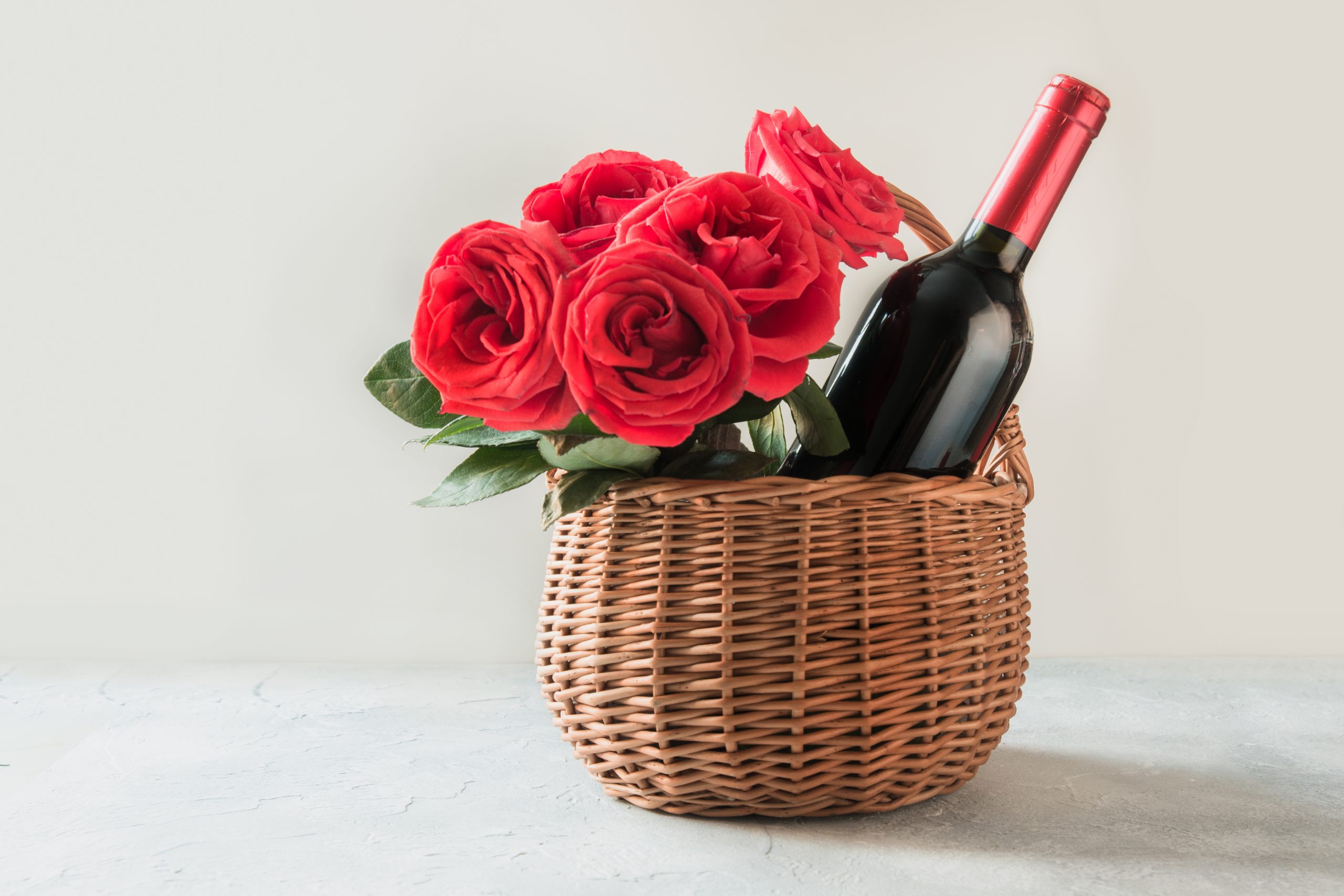 valentines day gift hamper and bouquet of red roses bottle of red wine 
