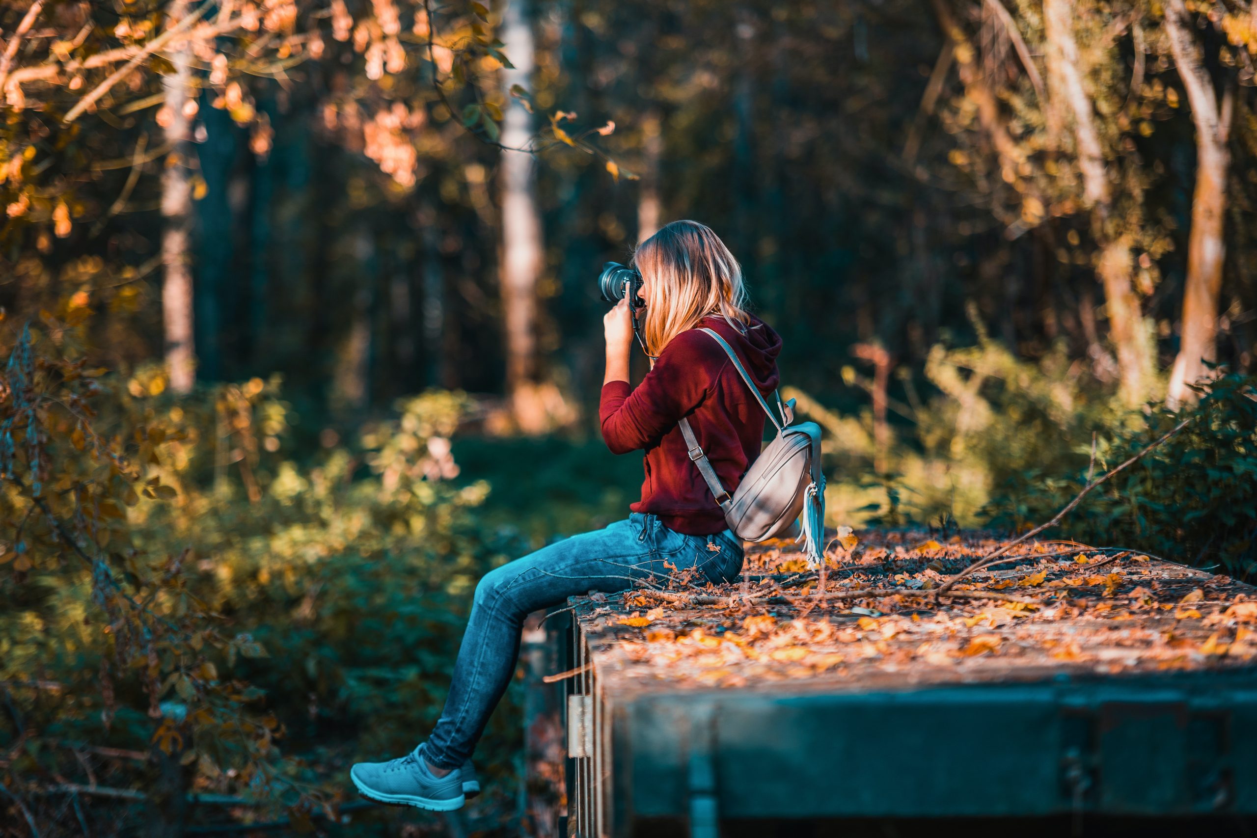 woman-sitting-in-the-woods-taking-picture-first-date-questions-to-ask