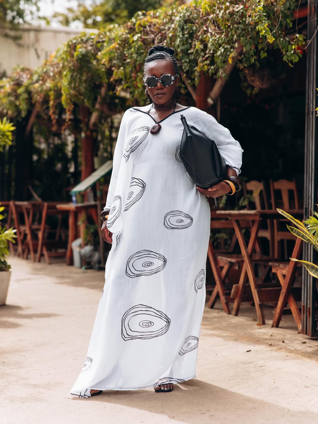 woman wearing oversized sunglasses and white dress for summer capsule wardrobe essential