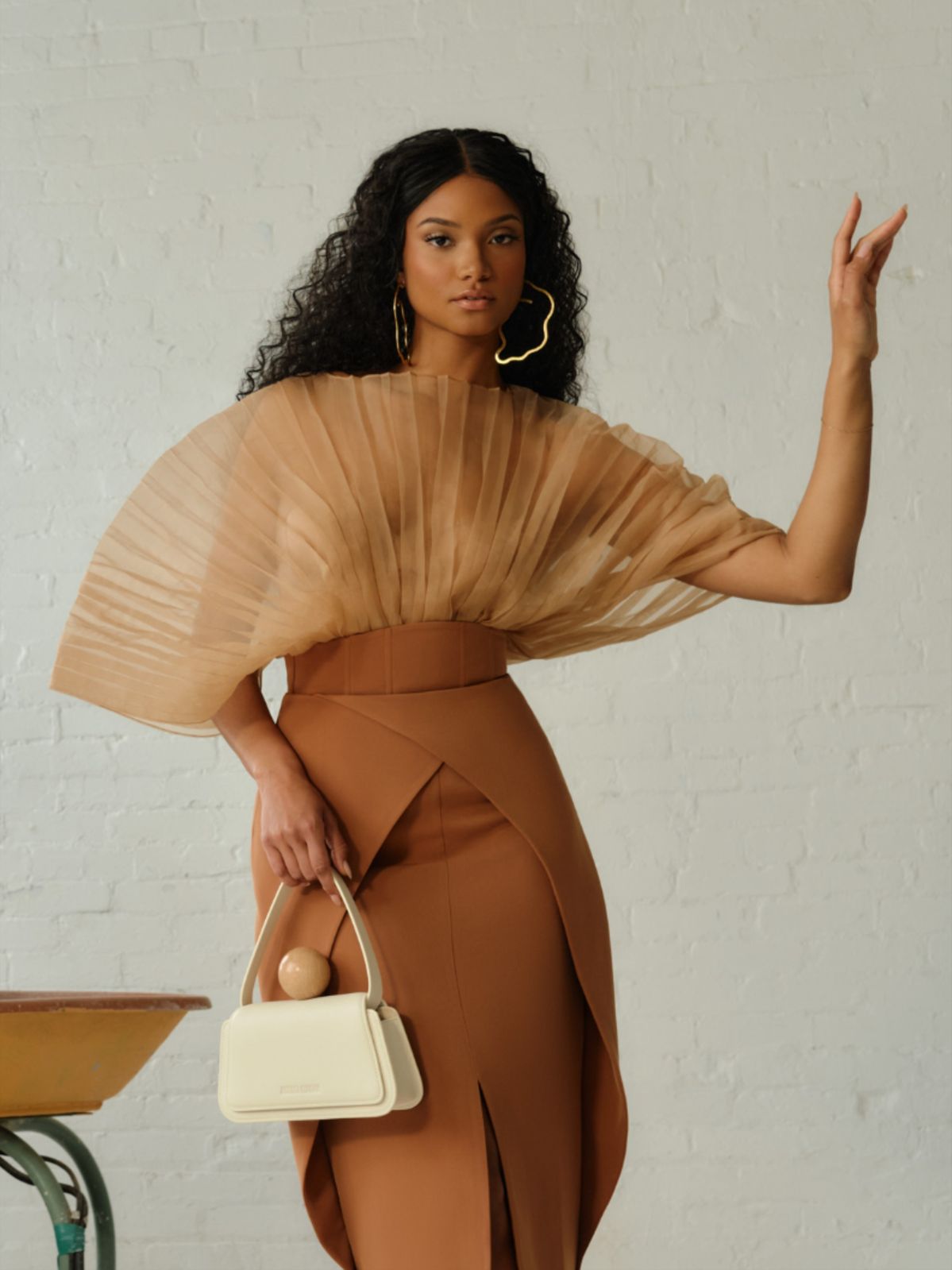 woman wearing mocha mousse pleated top and skirt