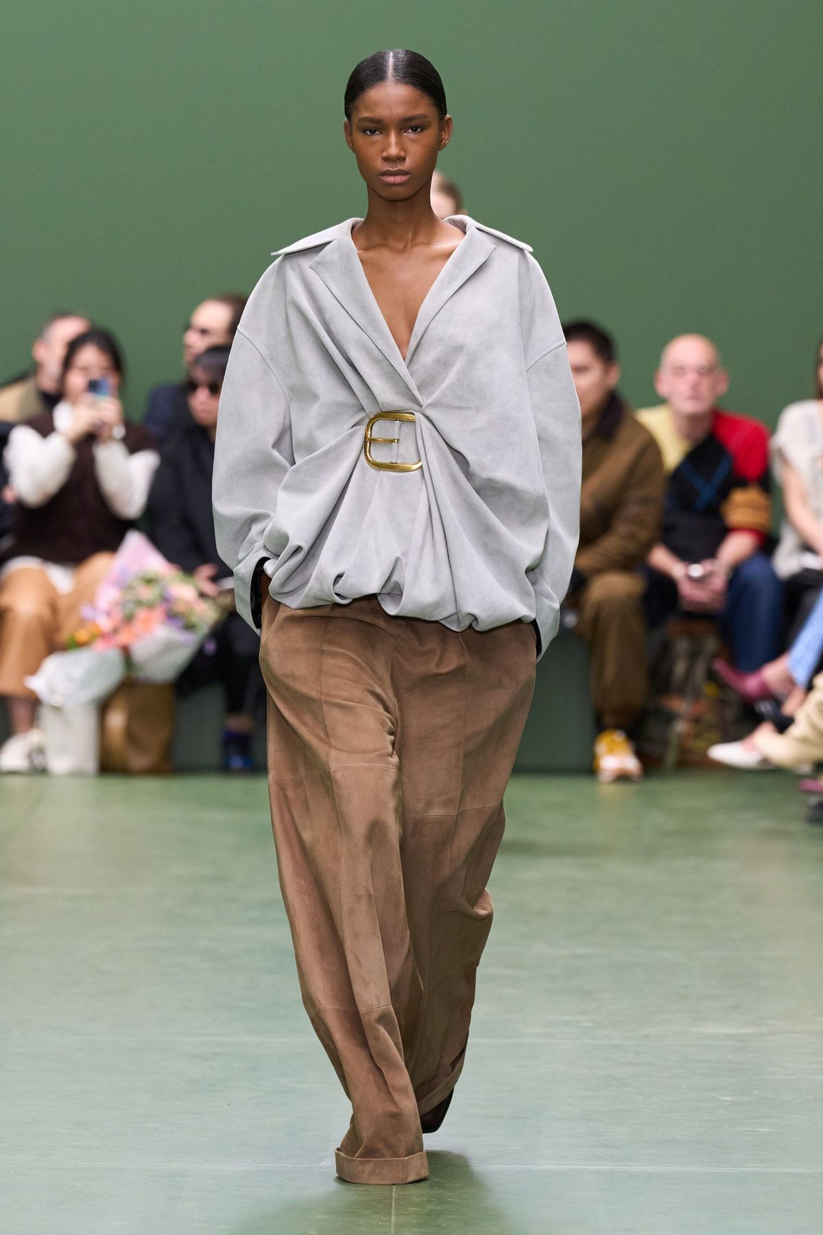 model on runway wearing brown baggy pants and oversized shirt