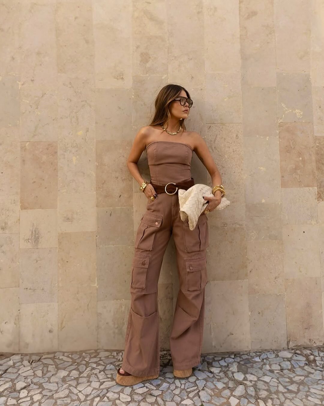 woman wearing mocha mousse jumpsuit with white purse