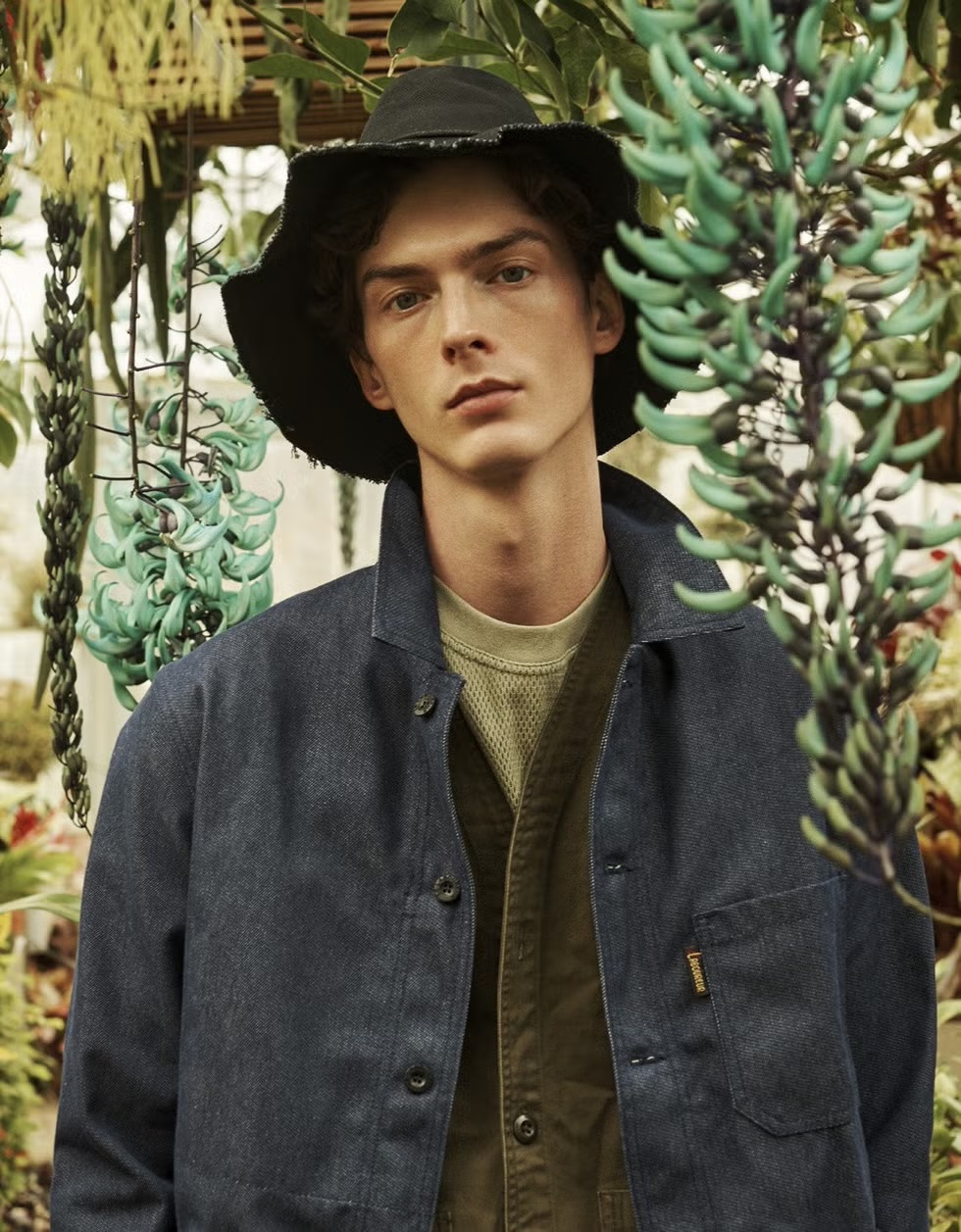 man wearing denim chore jacket with bucket hat