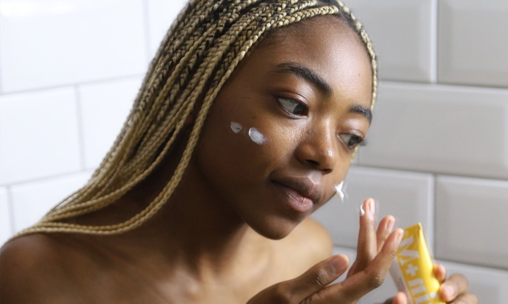 College student using a gentle face cleanser as part of fall skincare tips for students