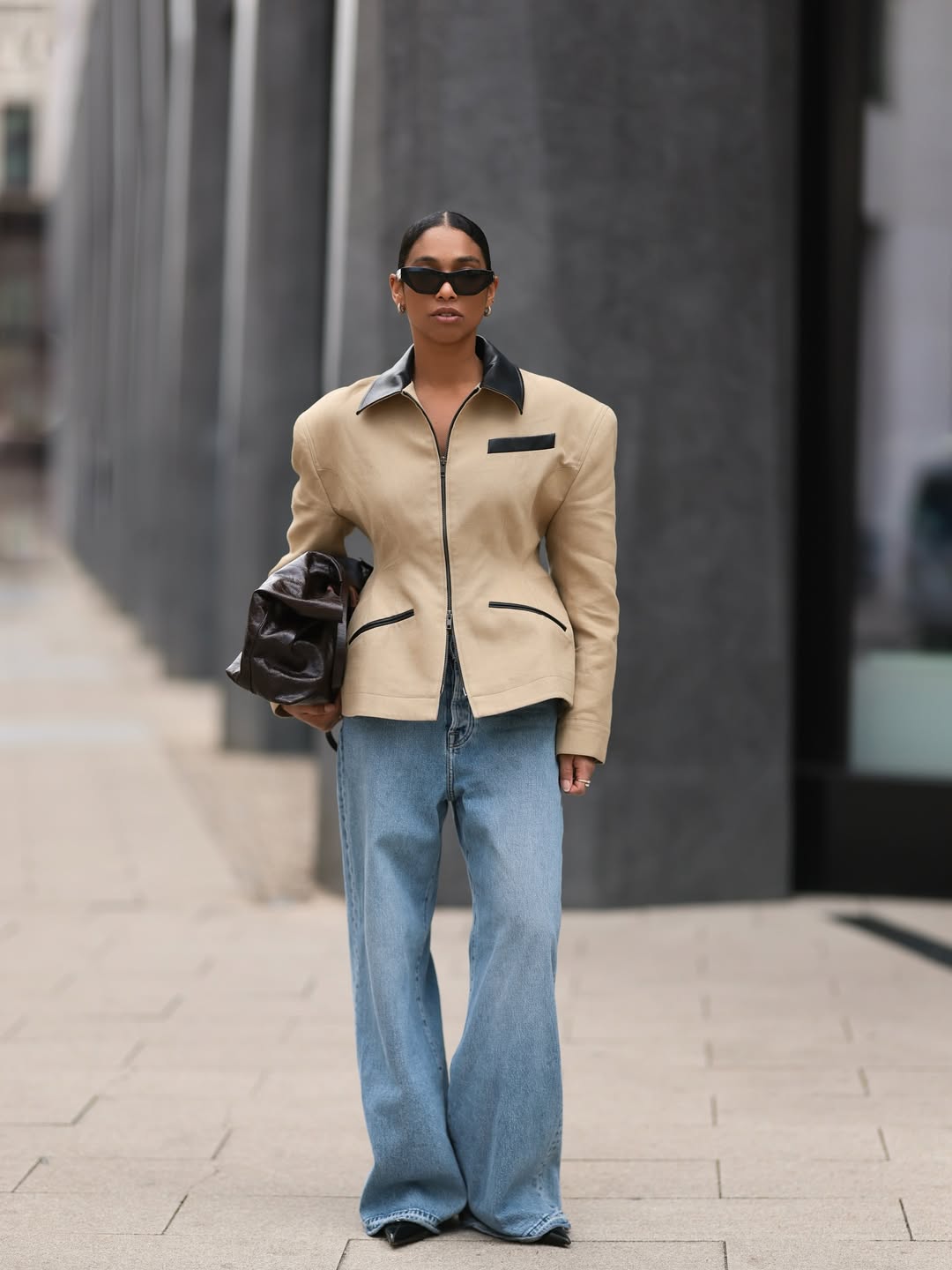 woman wearing flare jeans with brown jacket