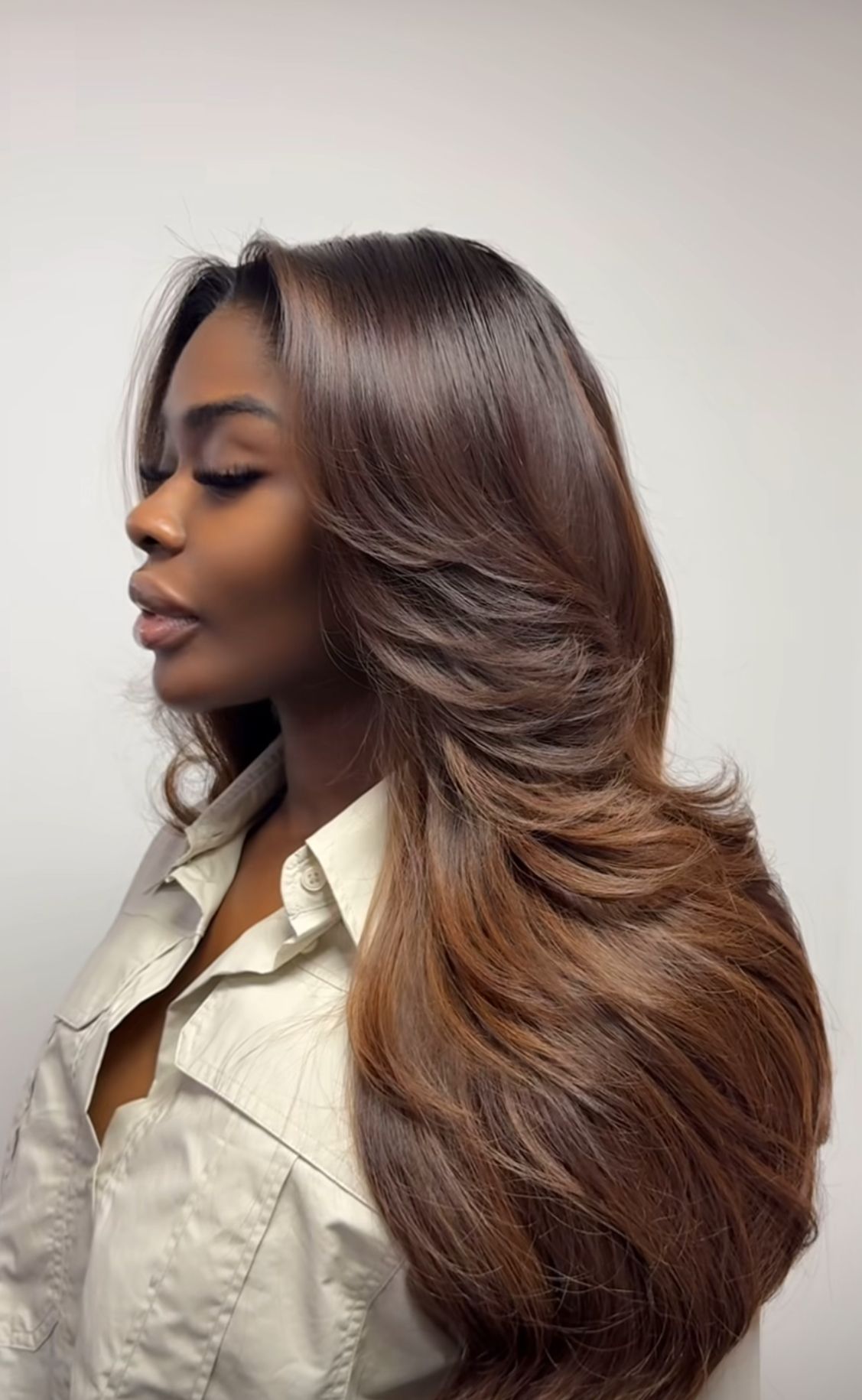 Long cascading layered haircut for women with wavy hair.