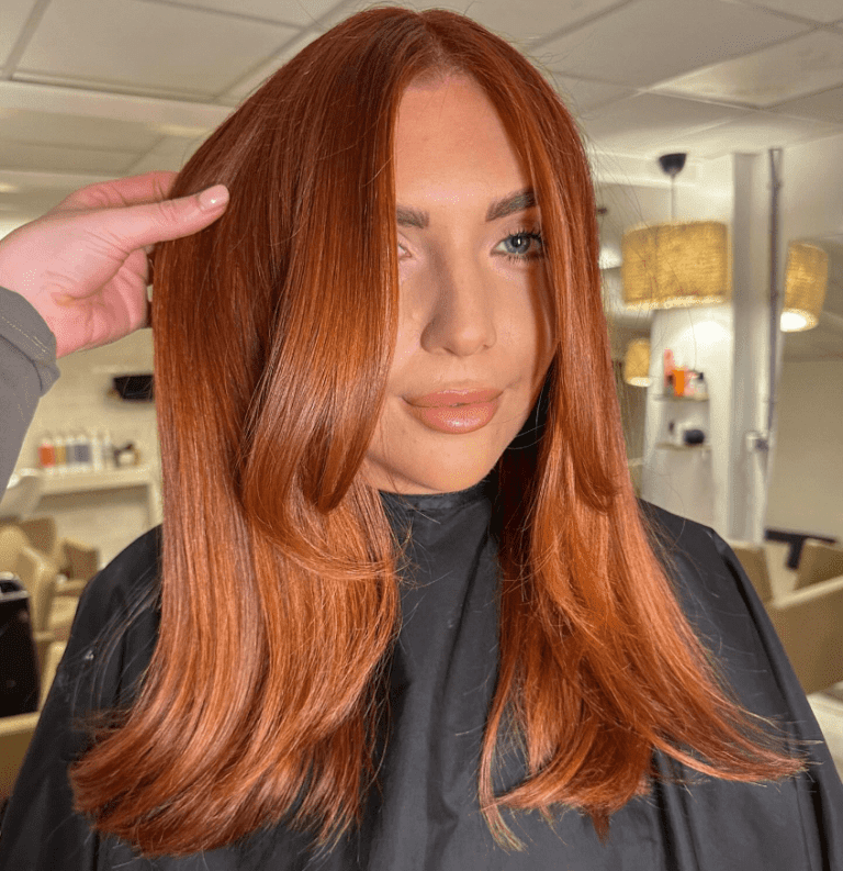 A close-up image of shiny ginger hair glowing in natural light — how to maintain ginger hair