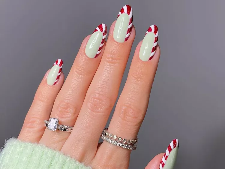 Candy cane Christmas nail art designs in red and white stripes.