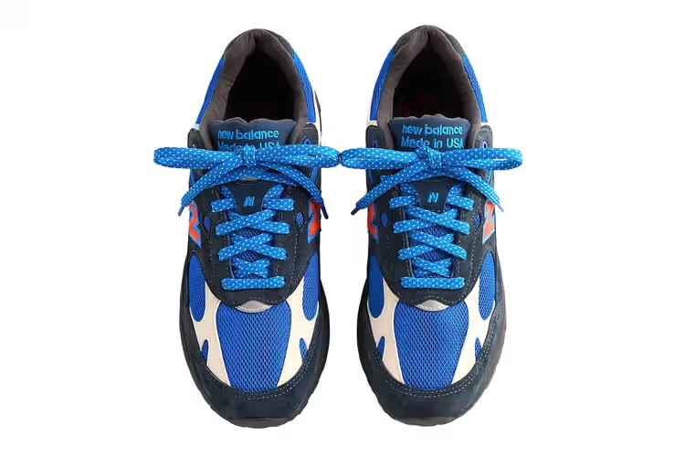 Kith x New Balance 993 “Away” edition with navy and black suede overlays and orange New Balance branding