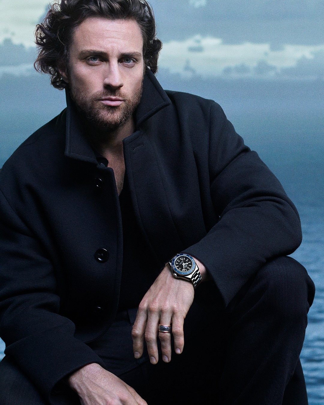 Aaron Taylor-Johnson wearing the blue Omega Seamaster Planet Ocean model.