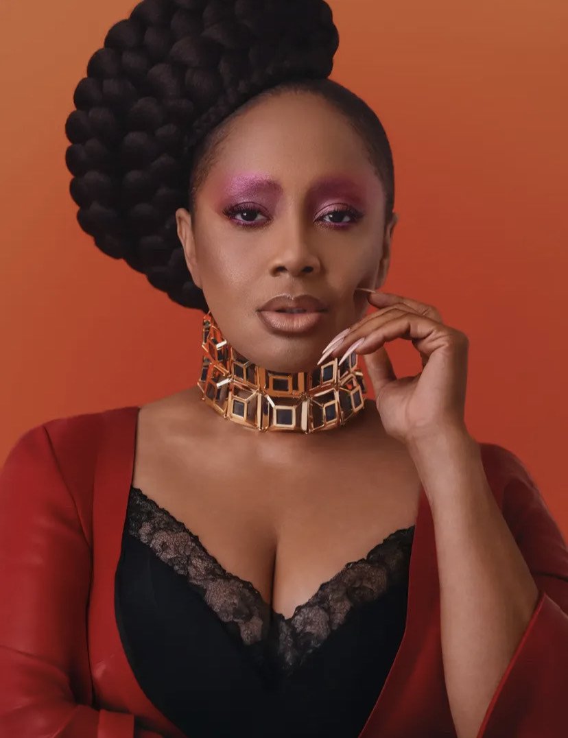 Lalah Hathaway wearing expressive beauty look with bold fuchsia shimmery eyeshadow and neutral glossy lips.
