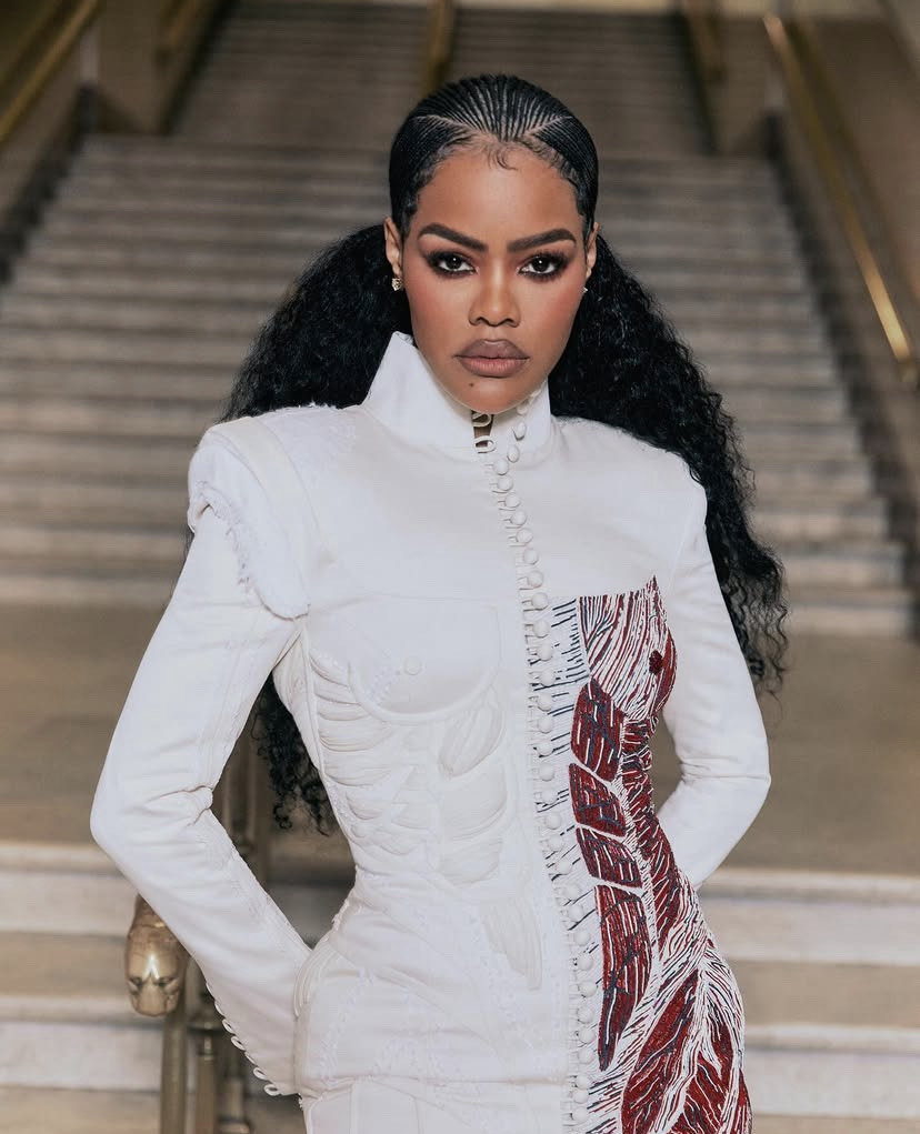 Teyana Taylor with expressive beauty look featuring smoky eyes, winged eyeliner, and nude glossy lips.