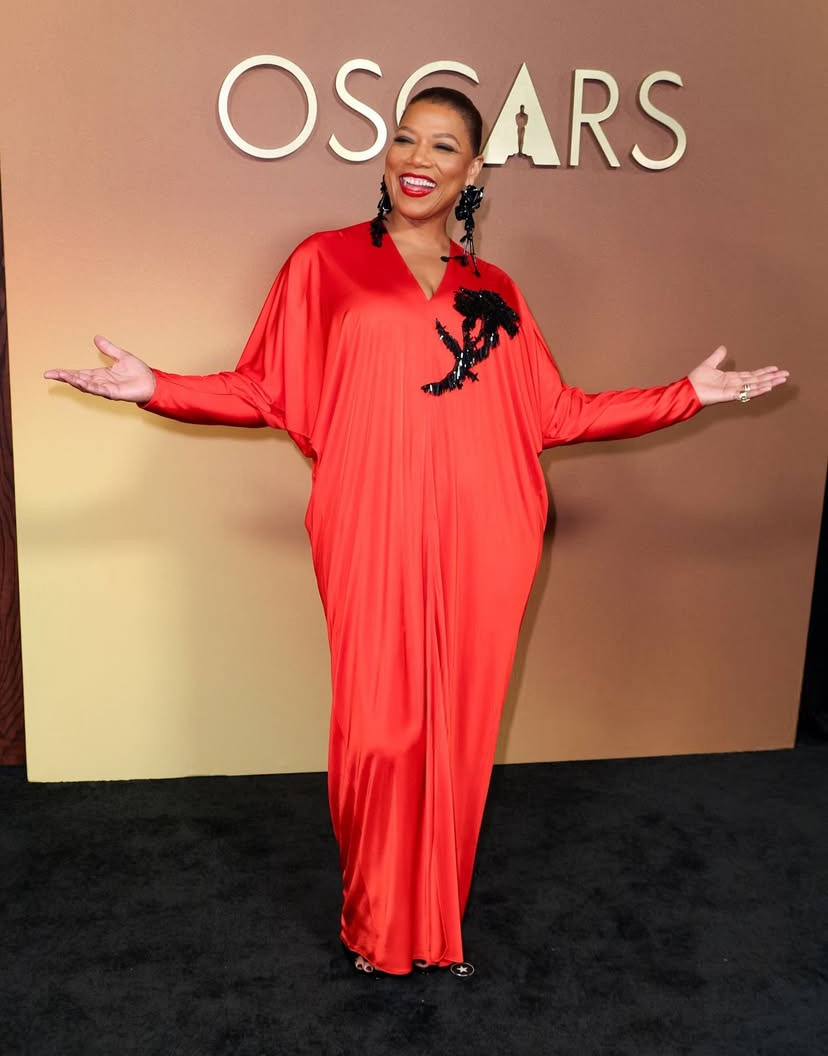 Queen Latifah wearing a satin draped gown that translates beautifully into an elegant celebrity Thanksgiving outfit idea.