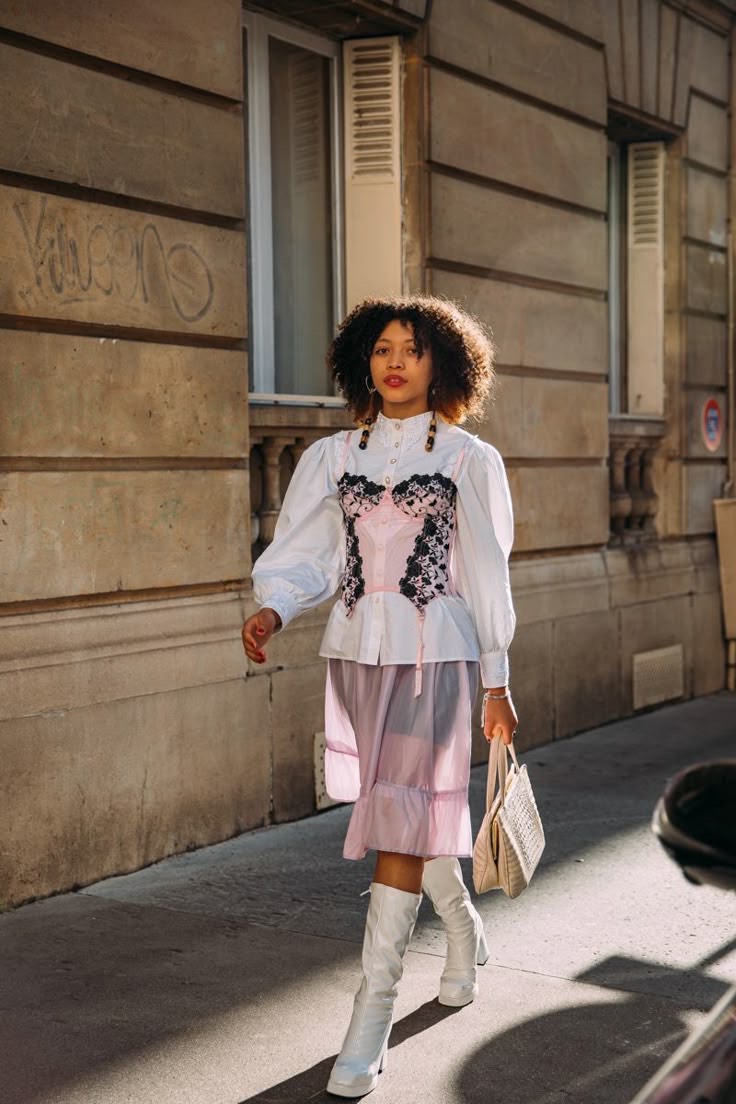 Corset top paired with shirt and skirt as part of the lingerie as clothes trend.