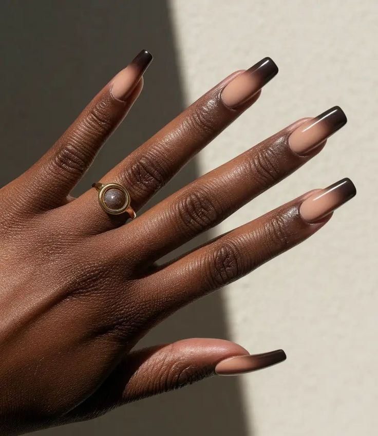 Soft black french tip nail designs on long coffin nails.