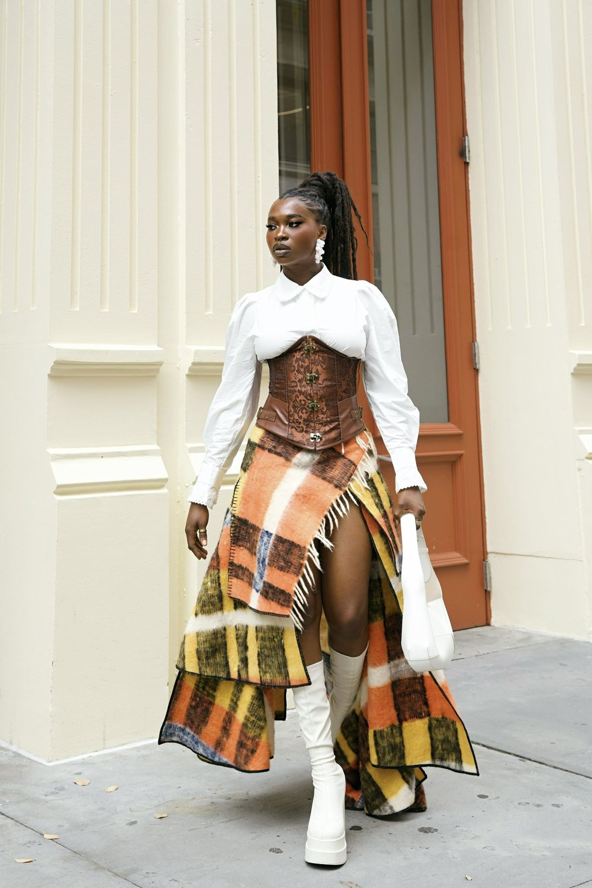 woman wearing checked maxi skirt with white shirt and corset 