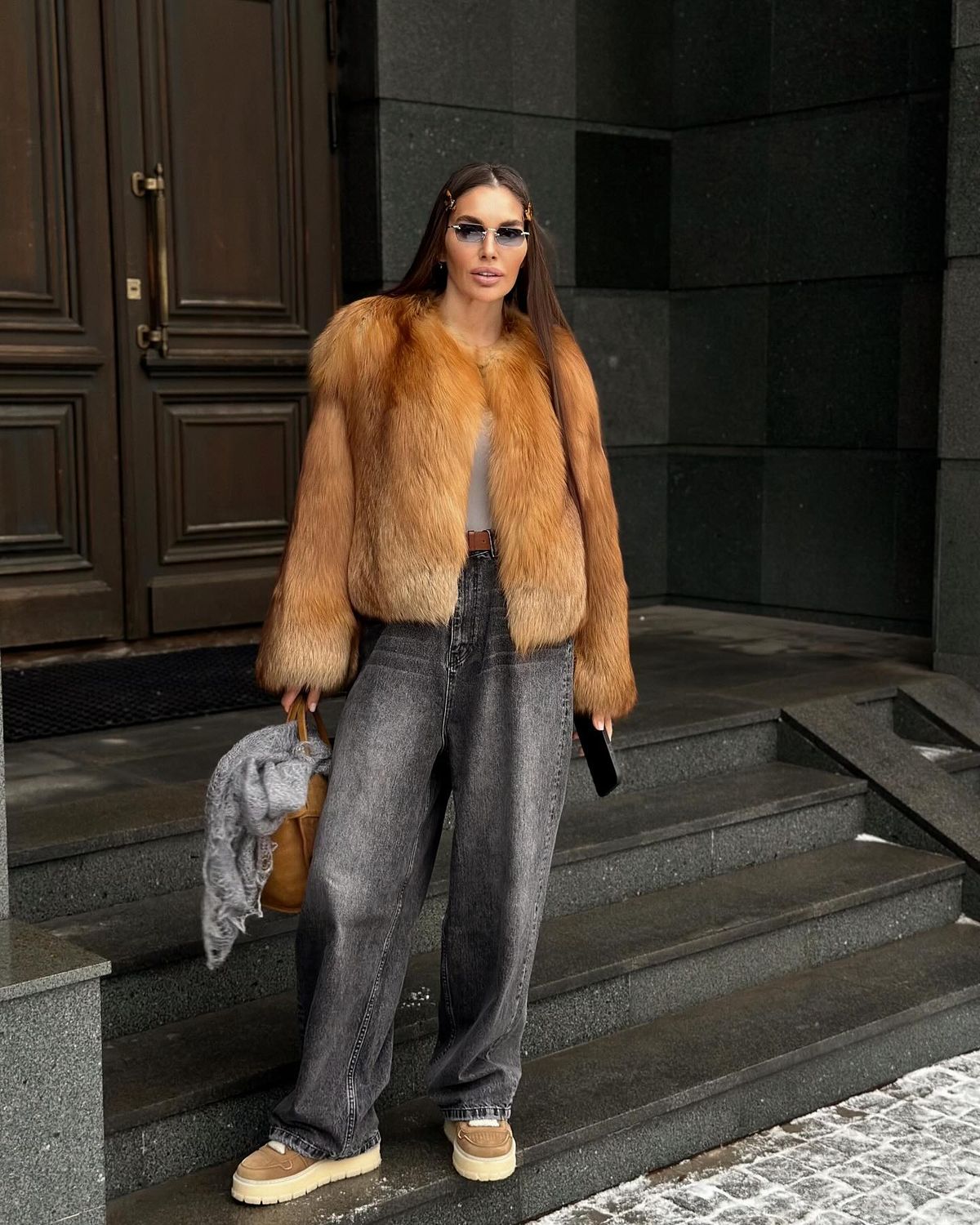 woman wearing mink coat with jeans and sneakers