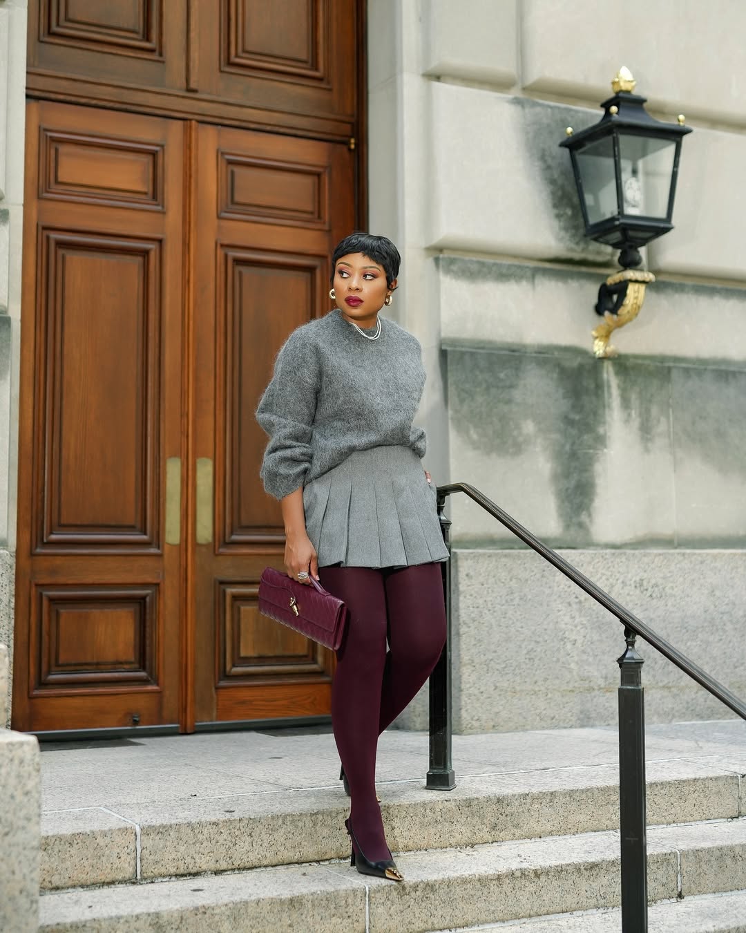 Burgundy tights outfit styled with a cream knit dress and tall boots for a winter outfit.