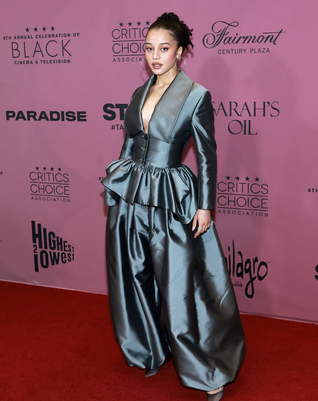 Chase Infiniti at the Critics Choice Association Celebration of Black Cinema and Television wearing a bold Christopher John Rogers design.