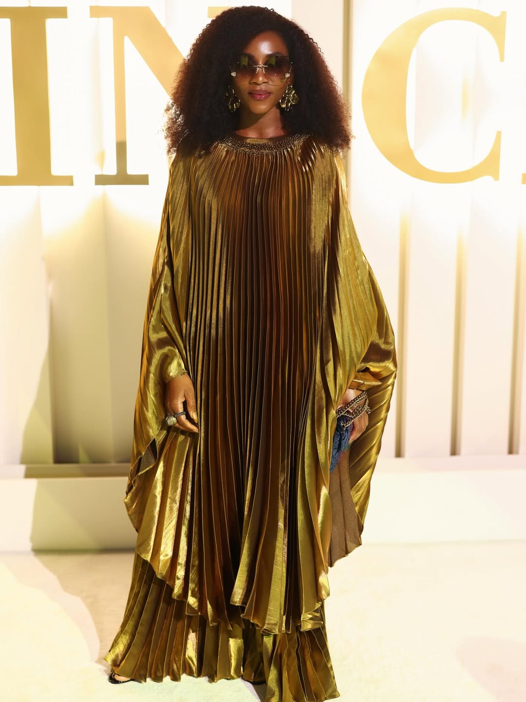 Genevieve Nnaji posing elegantly at the Red Sea International Film Festival in a refined evening look celebrating global cinema.