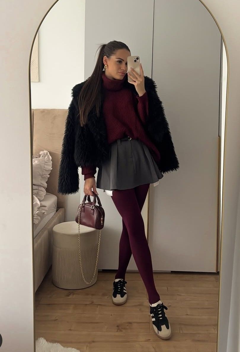 woman wearing burgundy tights outfit with sweater mini skirt and jacket