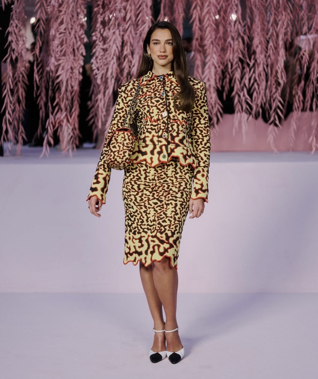 Dua Lipa wearing a patterned tailored set with scalloped details, reflecting couture-inspired style beyond haute couture week outfits