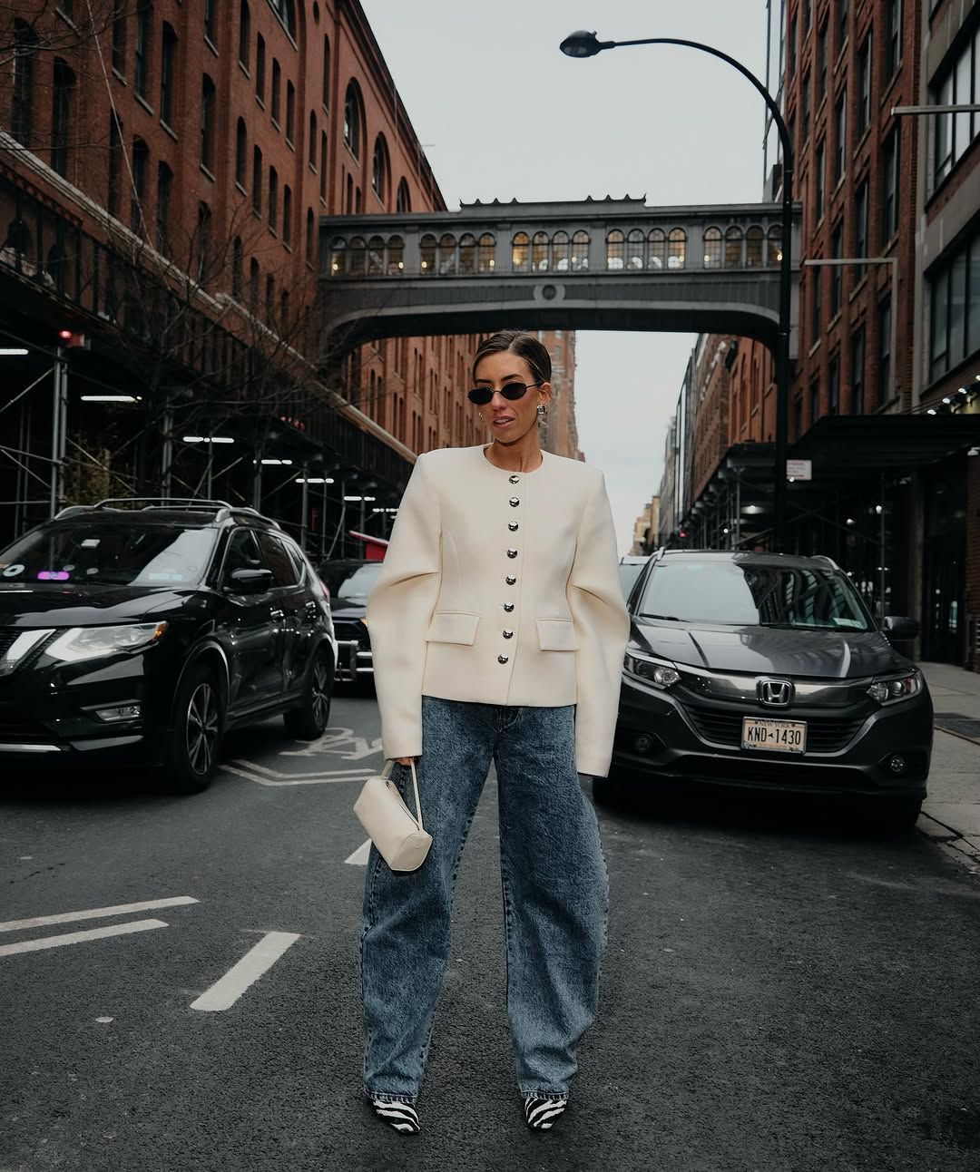 woman wearing cropped jacket and jeans