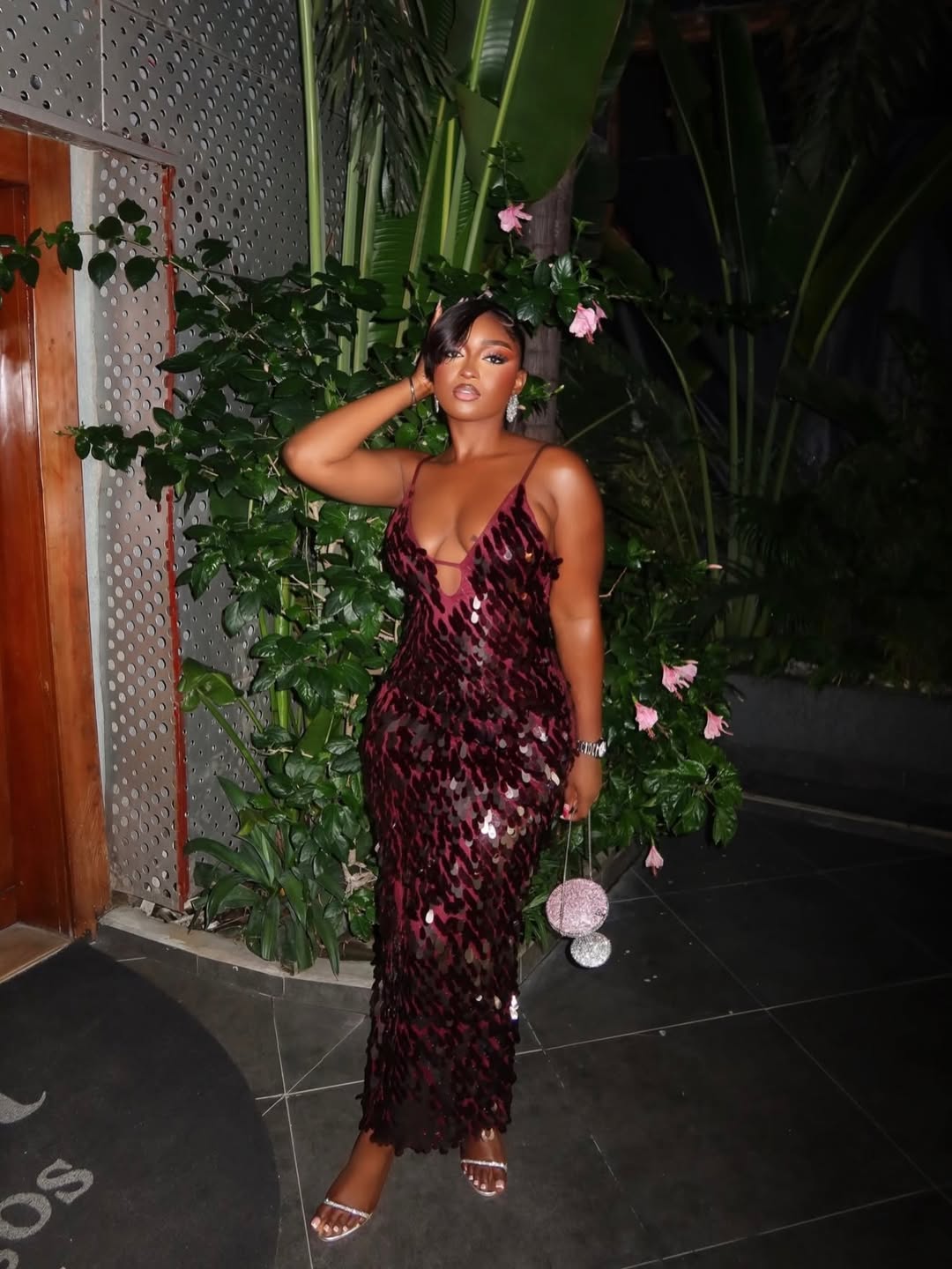 Женщина в модном темно-бордовом вечернем платье с пайетками