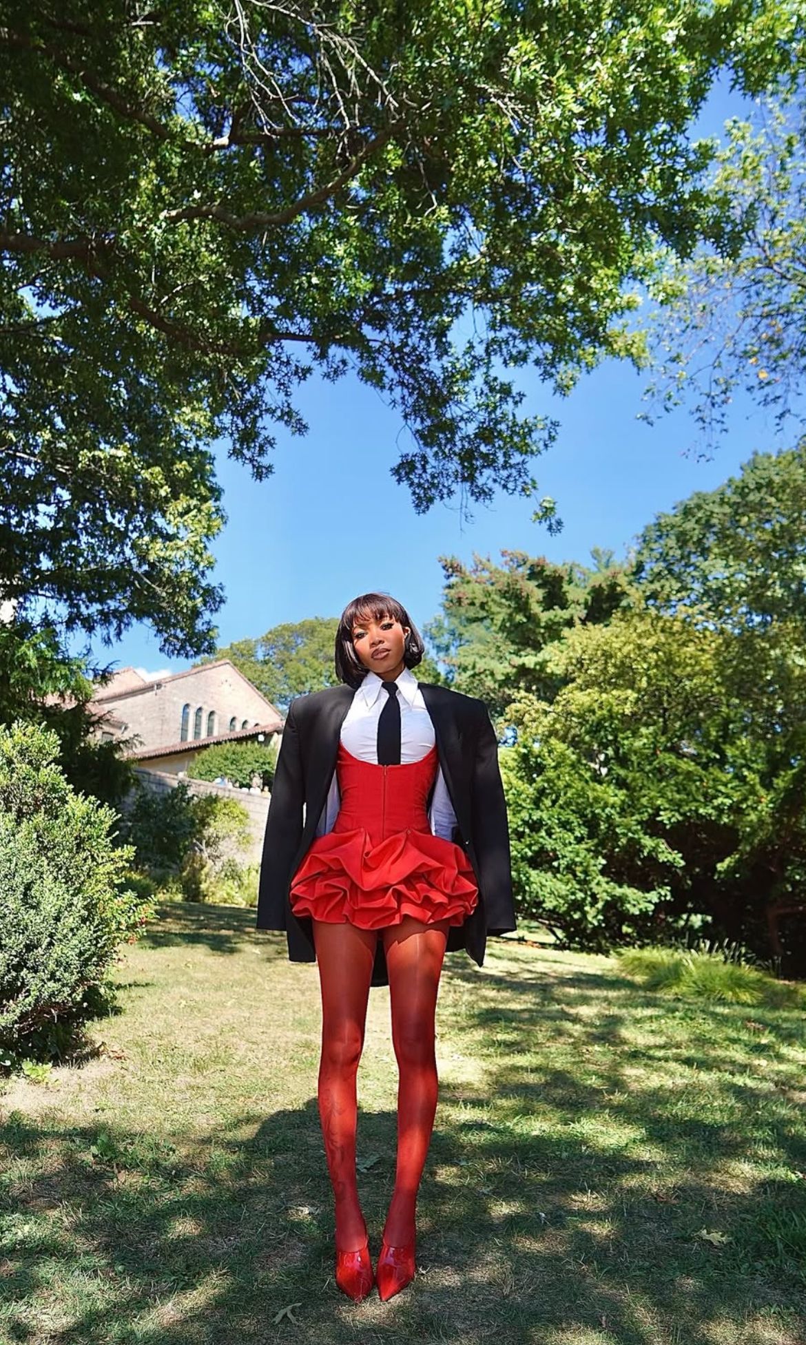 Bubble dress layered over shirt with sheer tights and pumps —Coquette-style outfit