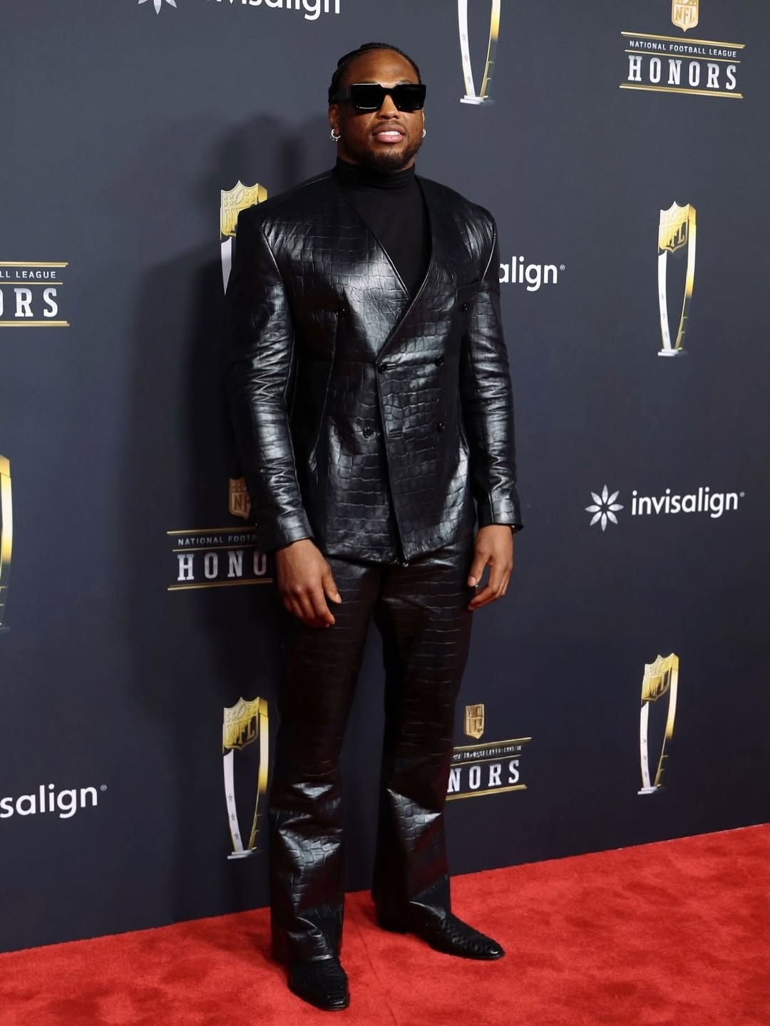 Derrick Henry arriving on the NFL Honors red carpet in a sleek all-black tailored look.