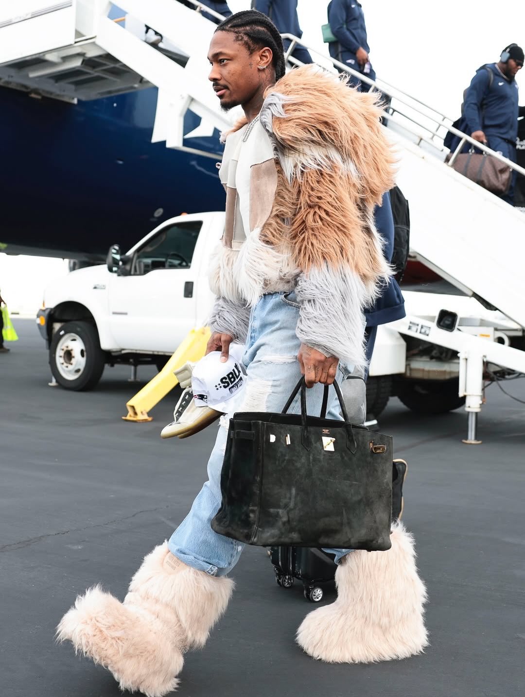 Stefon Diggs arriving in San Francisco ahead of Super Bowl LX in a polished travel outfit.