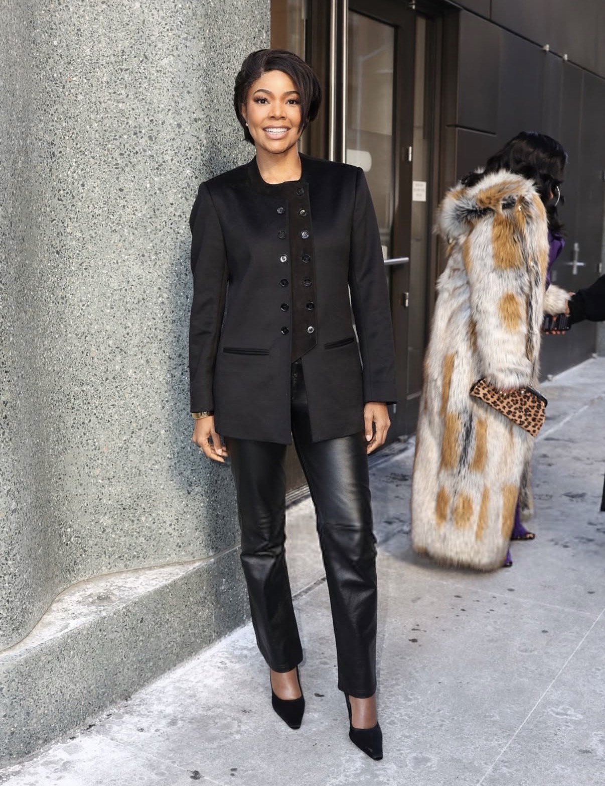 Gabrielle Union wearing a black longline cashmere blazer with leather trousers and pointed-toe heels styled with a short hairstyle and gold bracelet — Valentine party outfit ideas