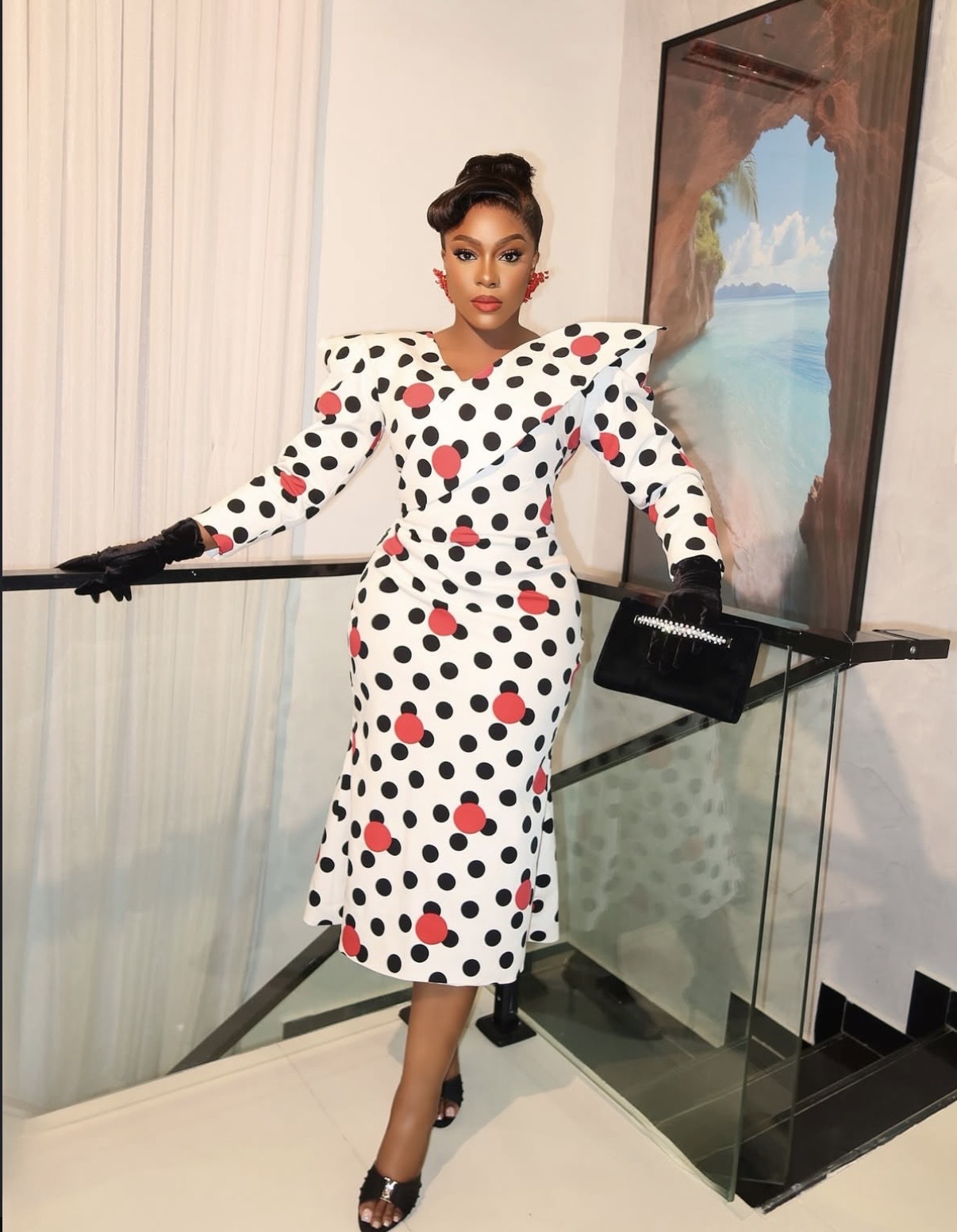 Ego Nwosu in retro-inspired polka dot midi dress with red heart motifs at Love and New Notes film premiere