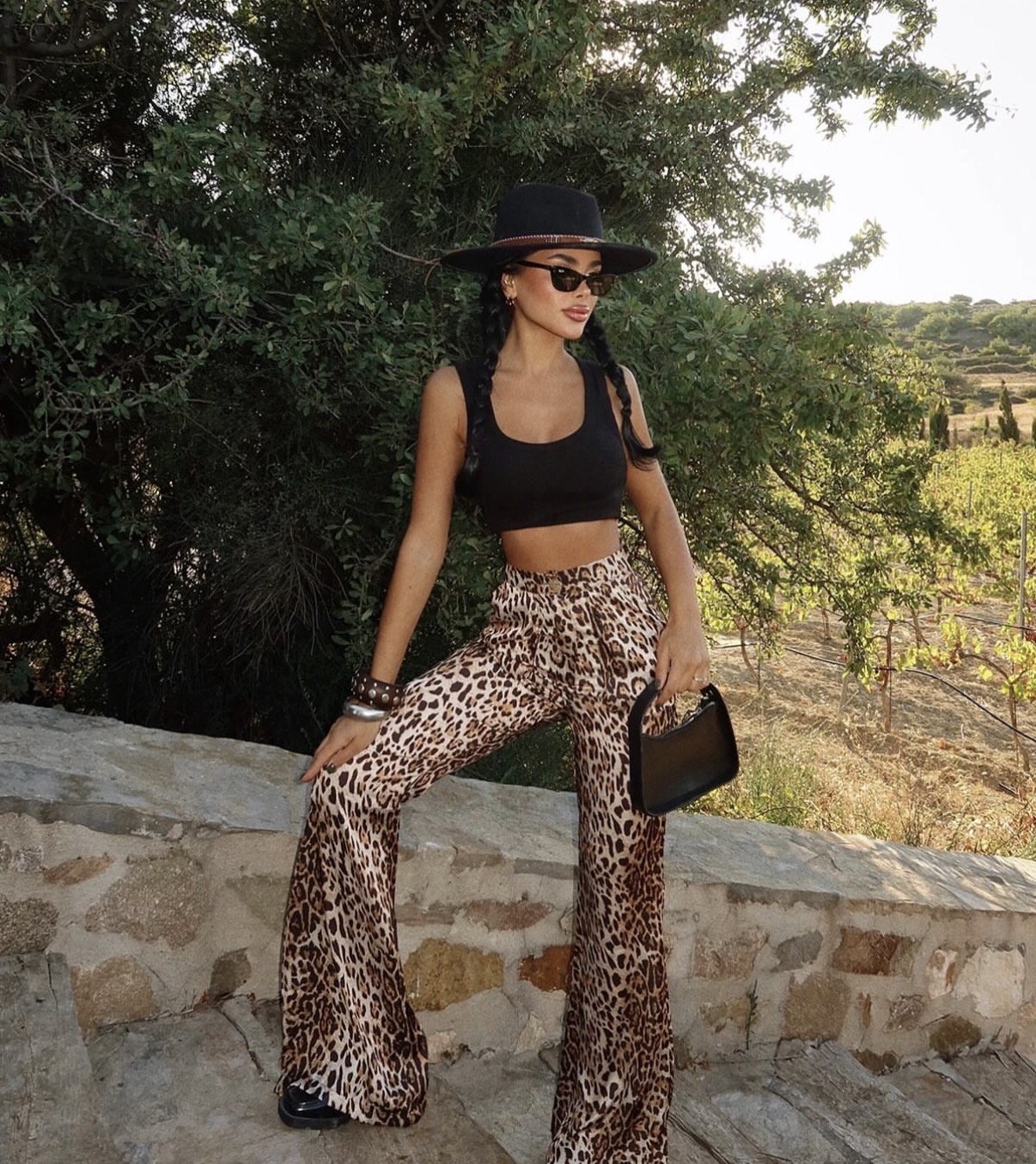 Animal print pants paired with leather jacket for edgy boho concert styling— concert outfit ideas women