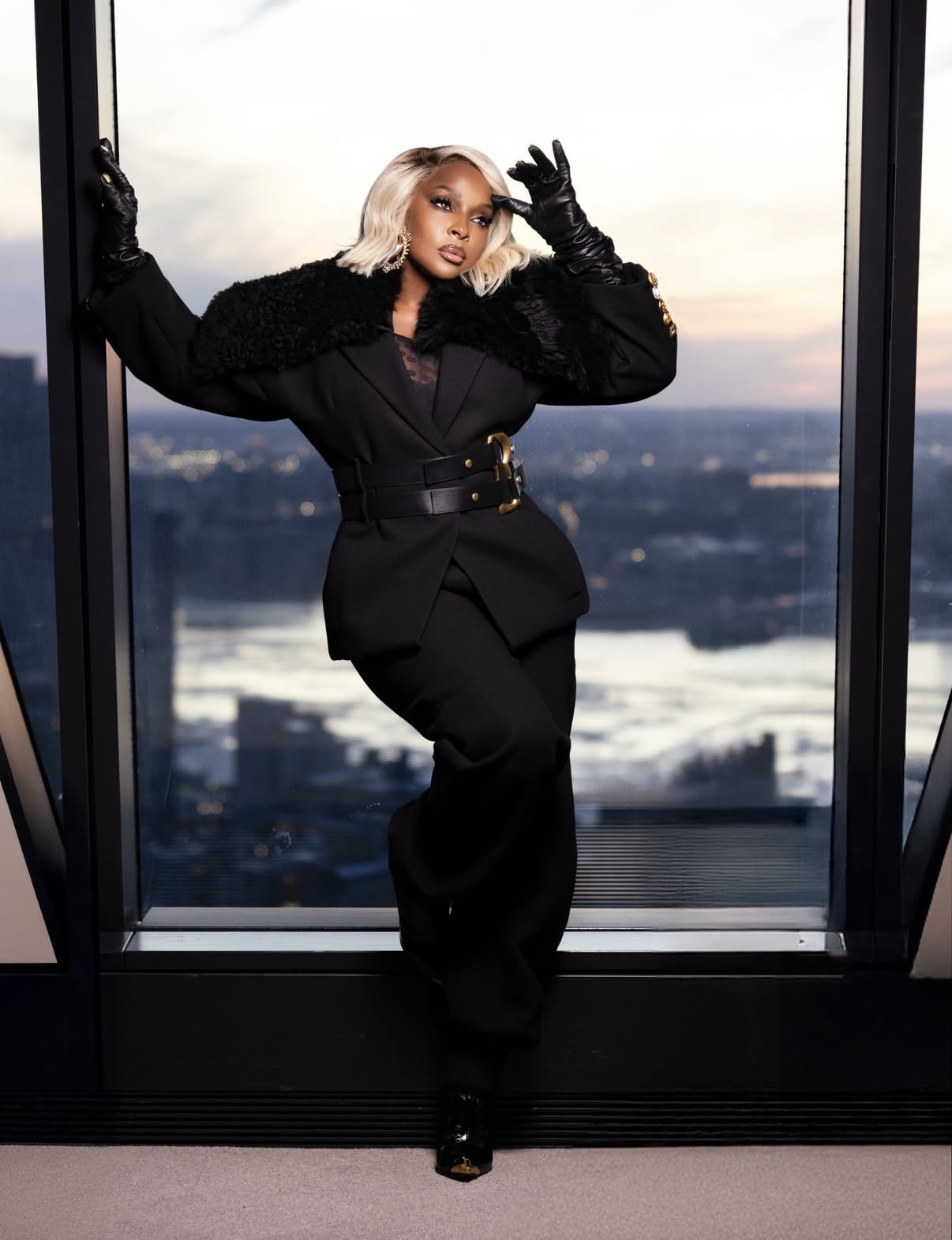 Mary J. Blige wearing a sculpted all-black Schiaparelli power suit with shearling details and wide-leg trousers in a dramatic high-fashion tailoring moment — 2026 New York Fashion Week styles