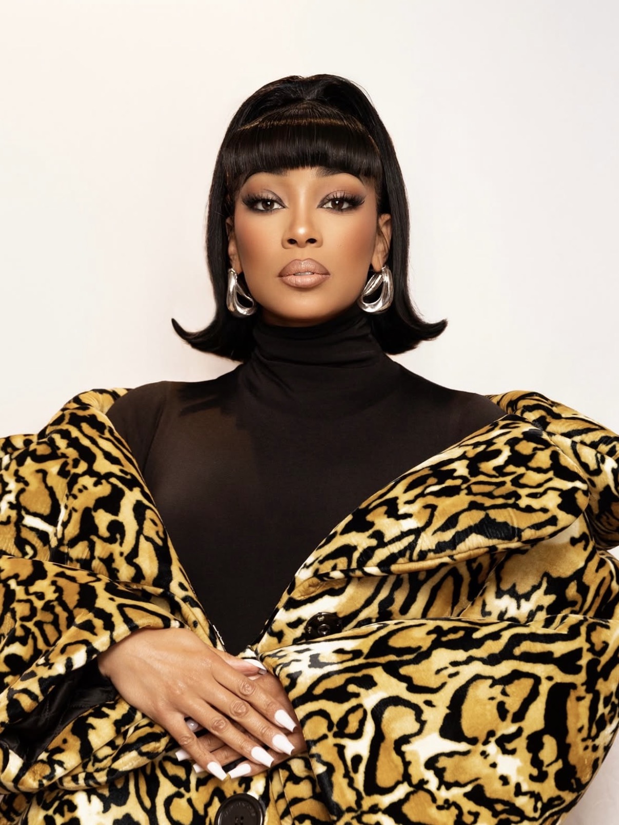 Monica Denise's 1960s-inspired flipped bob with structured bangs — retro-inspired beauty glam