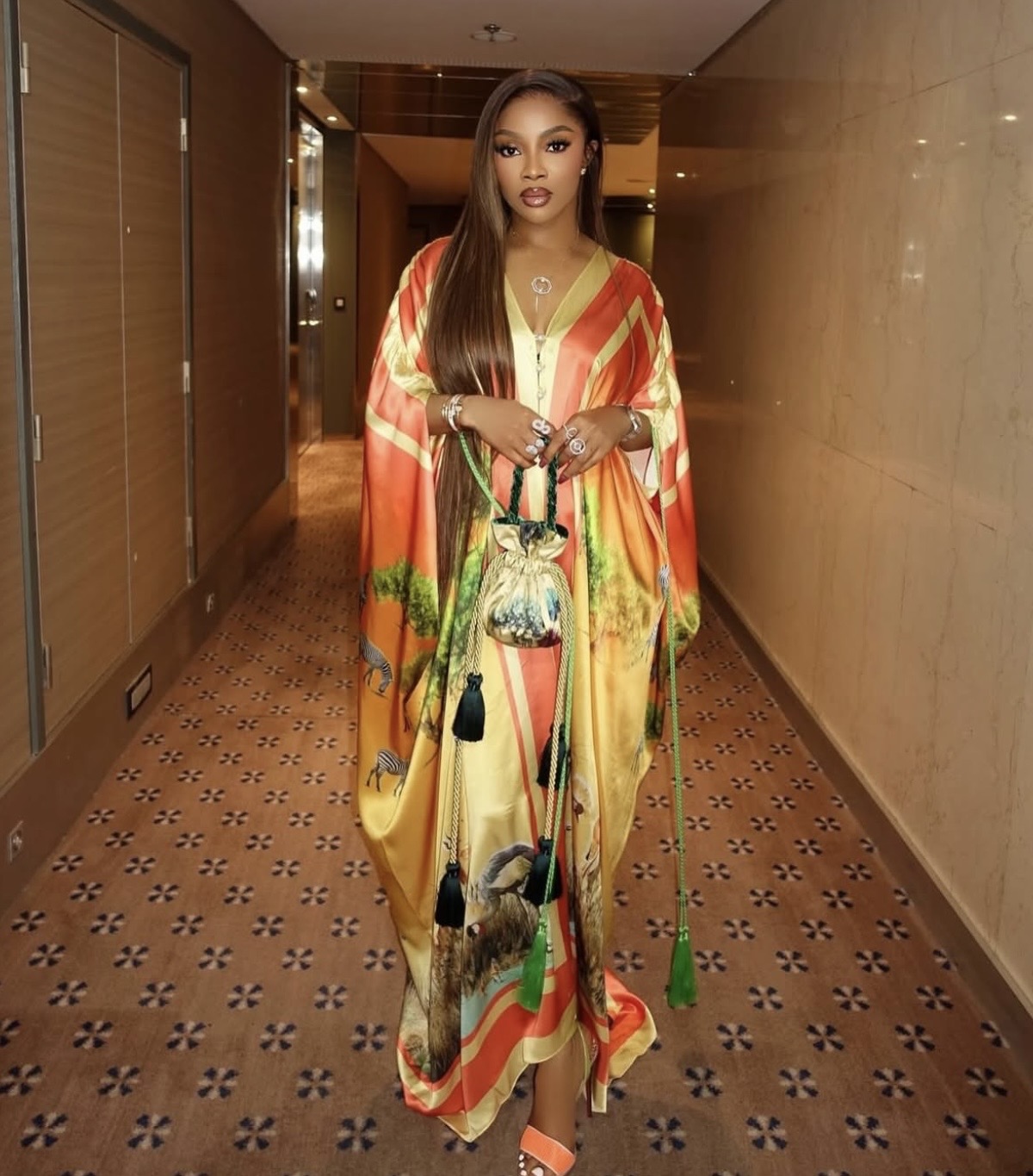 Toke Makinwa showcasing showcasing vibrant Nigerian fashion in a colorful kaftan