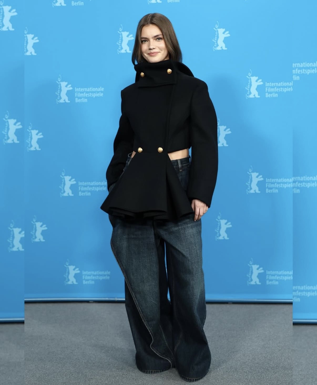 Florence Hunt in a cropped black Dior jacket with wide-leg denim jeans at the Berlin International Film Festival photocall— Edgy celebrity outfits