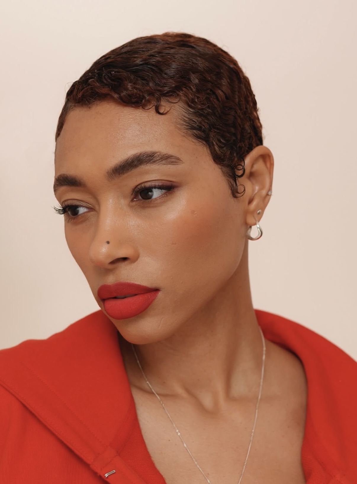 Model wearing stain blush across cheeks and nose for natural flush — stain makeup trend