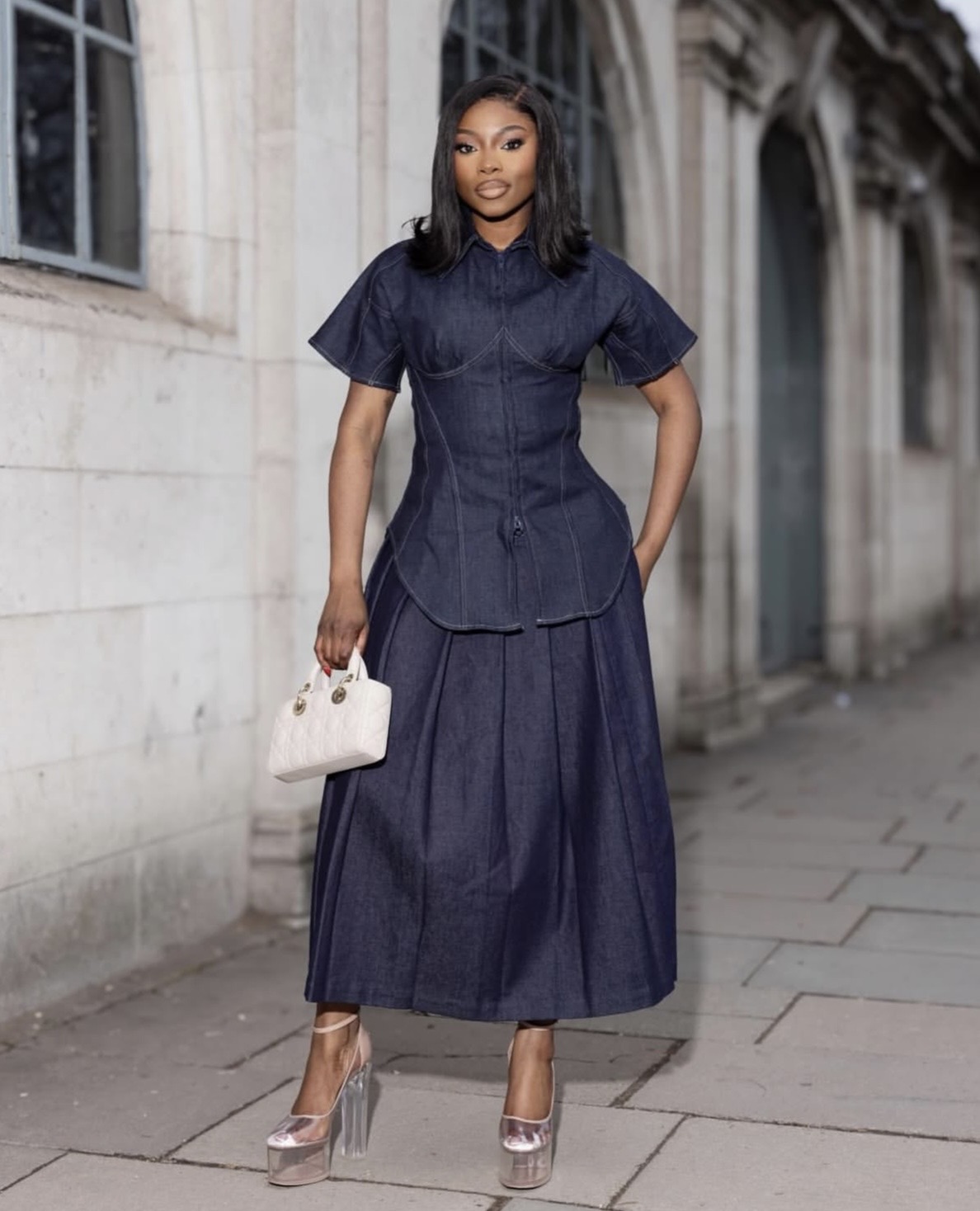 Structured denim shirt tucked into high-waisted denim midi skirt for a work denim on denim 2026 trend