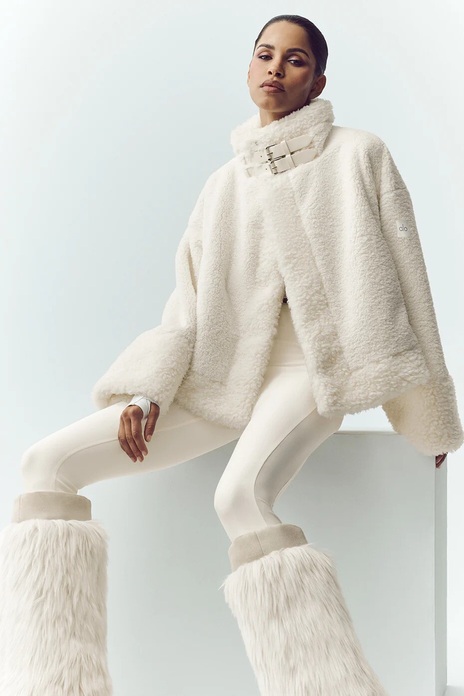 woman wearing a white bomber jacket with joggers