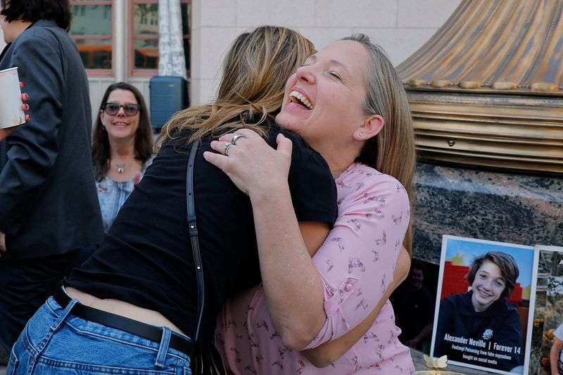 Amy Neville, mother of Alexander, is embraced outside the court as she awaits the jury's verdict