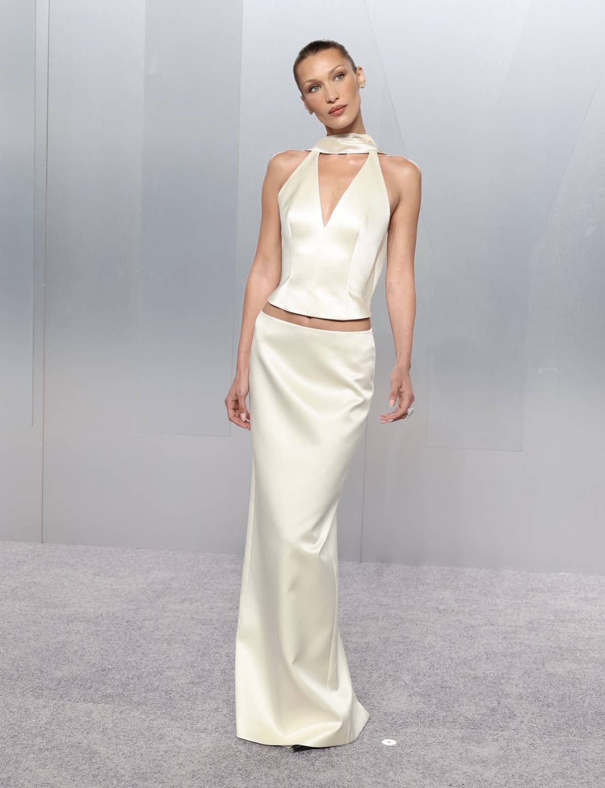 Bella Hadid wearing an off-white Prada silk halter top and matching floor-length skirt at the 2026 Vanity Fair Oscars after-party