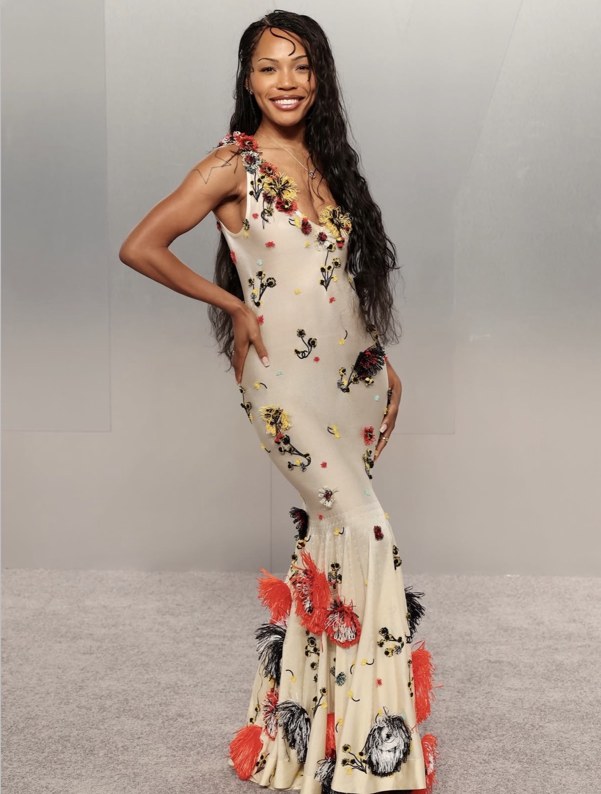 Quenlin Blackwell wearing a cream Chanel gown with colorful embroidery and feathered hem at the 2026 Vanity Fair Oscars after-party.