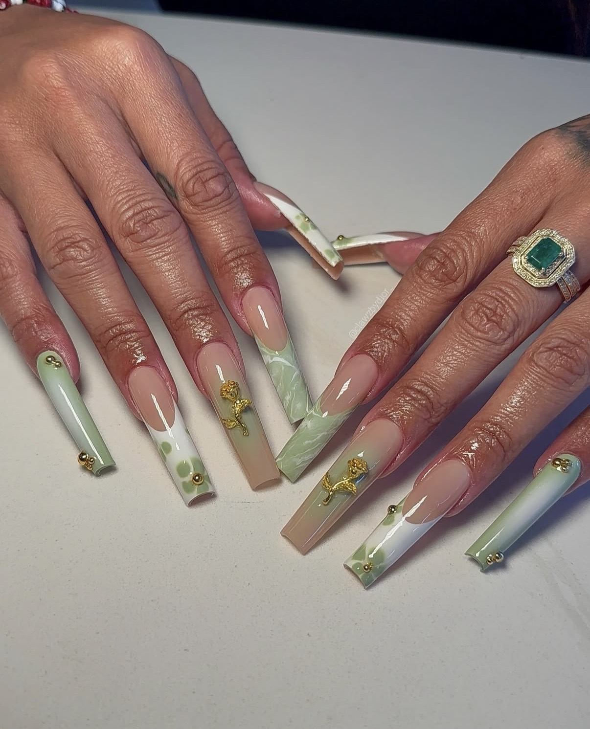 Long sage green French tip nails with gold charms and stud accents — sage green nails for spring