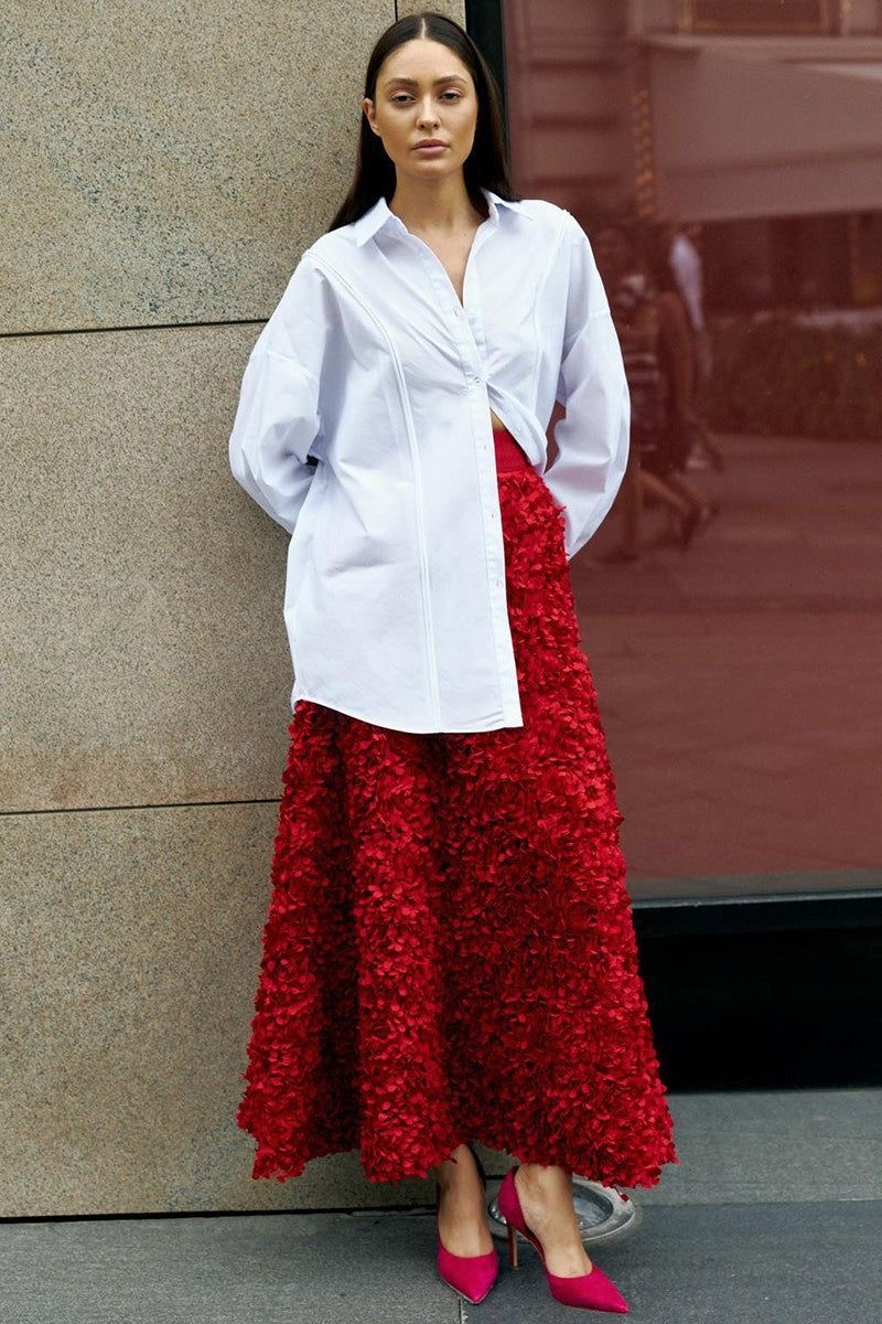 Oversized white shirt with red textured A-line maxi skirt featuring floral details— A-line maxi skirt styling tips