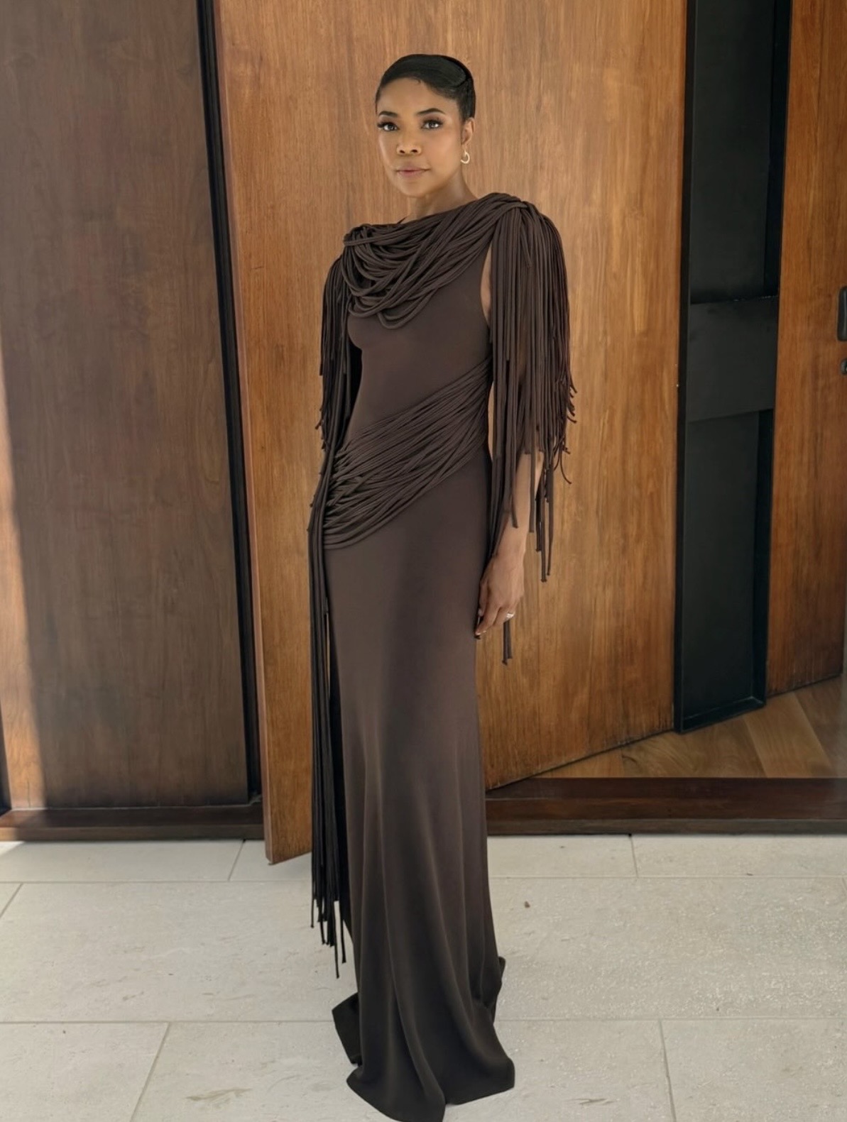 Gabrielle Union wearing a brown fringe detailed Altuzarra gown with a draped silhouette— celebrity street style fashion 2026